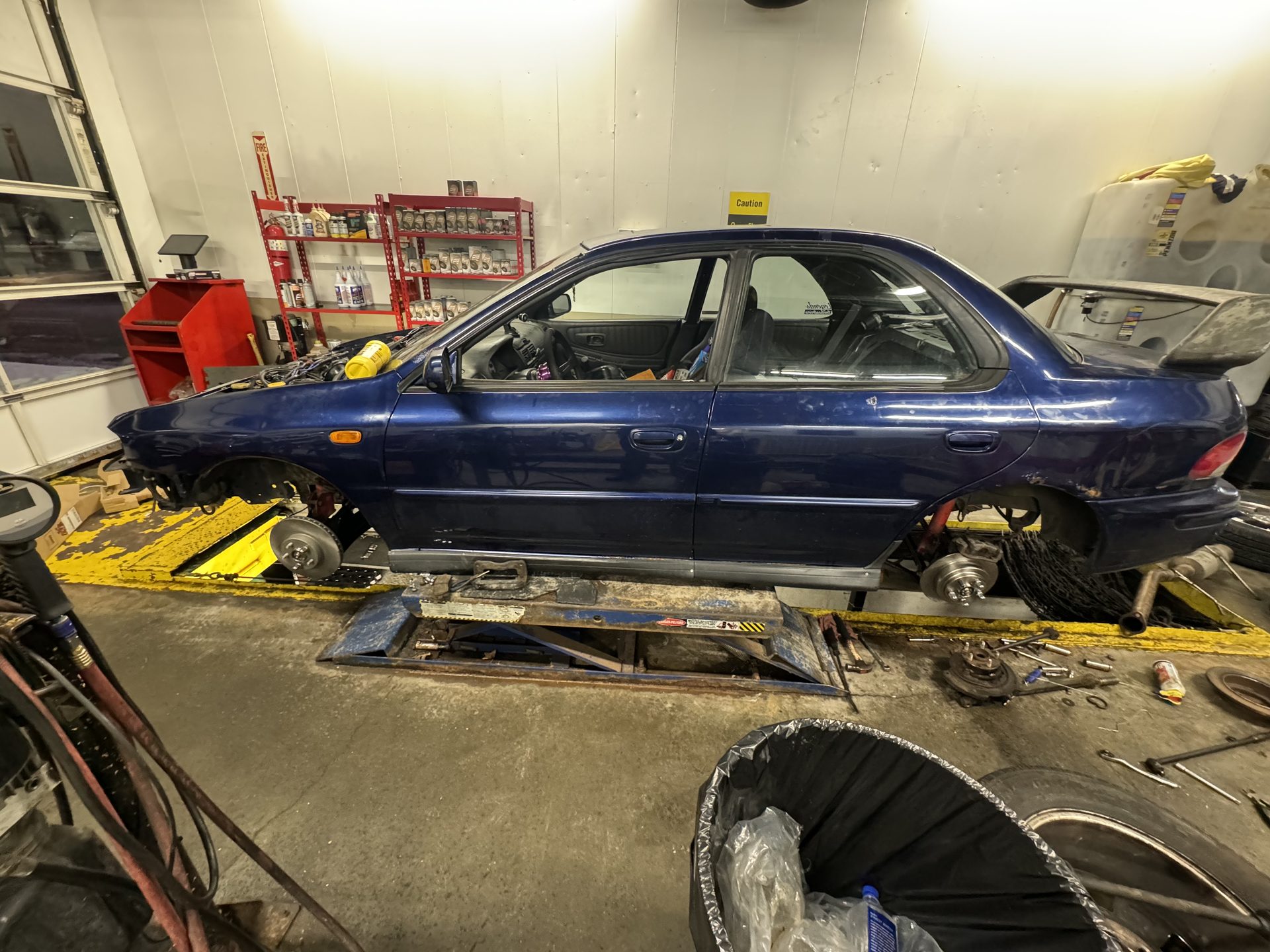 Subaru on a lift with the wheels off